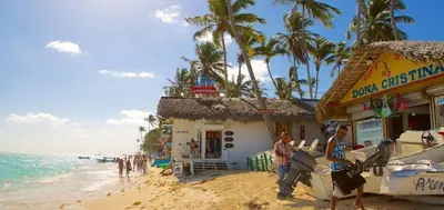 a building on the beach next to the ocean at Escapada Perfecta Piscina 5 Min a la Playa in Punta Cana