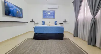 a bedroom with a blue bed sitting on a floor at Escapada Perfecta Piscina 5 Min a la Playa in Punta Cana