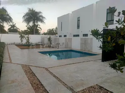a swimming pool in the backyard of a house at Pure relax in Bavaro La Casita de Giò in Punta Cana