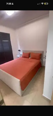 a bedroom with a large bed with red sheets and pillows at Luz y paz