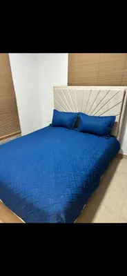 a bed with blue sheets and blue pillows at Luz y paz