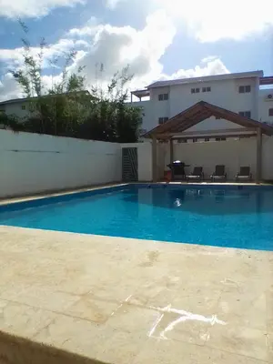 a large blue swimming pool in front of a building at Tropical oasis rentas in Las Terrenas