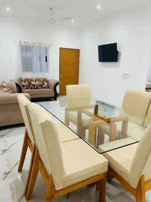 a living room with a glass table and chairs at Tropical oasis rentas in Las Terrenas