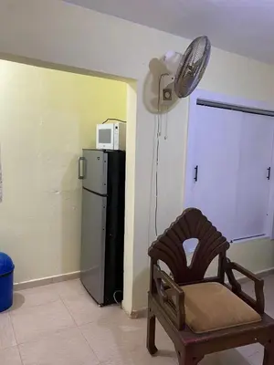 a room with a chair and a refrigerator and a fan at Nido del patio, 40 min to Bocachica beach 5 center in La Piedra