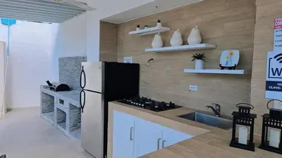 a kitchen with a refrigerator and a sink at Casa campo Ana Victoria