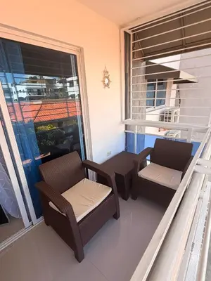 a balcony with two chairs and a window at Apartamento de lujos Avenida España