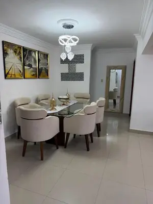 a dining room with a table and chairs at Santo domingo Avenida España