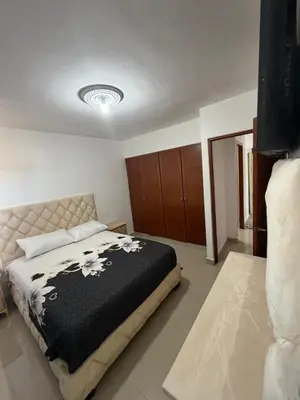 a bedroom with a bed with a black blanket at Santo domingo Avenida España