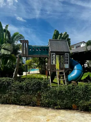 a playground with a play house and a slide at Penthouse with Jacuzzi Near Beach in Las Terrenas