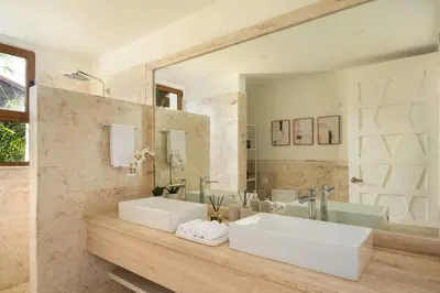 a bathroom with two sinks and a large mirror at Luxury 3BR Penthouse in Casa de Campo, Gated Resort Living & Golf View in La Romana