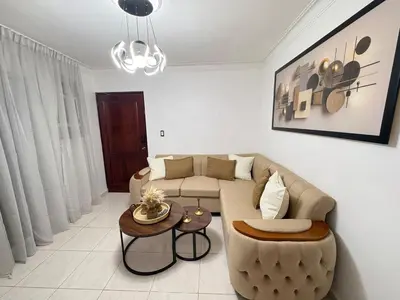 a living room with a couch and a table at Cómodo y moderno apartamento en Santiago Gurabo Sin costo de limpieza in Santiago de los Caballeros