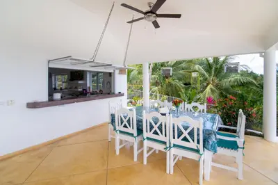 a dining room with a blue and white table and chairs at Villa Bella Vista - Luxury Ocean View and Private Pool, Las Terrenas in Las Terrenas