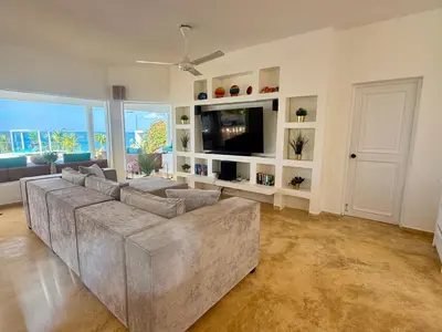 a large living room with a couch and a tv at Villa Bella Vista - Luxury Ocean View and Private Pool, Las Terrenas in Las Terrenas