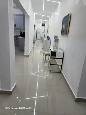 a living room with white walls and a white tile floor at Colonial suites in Santo Domingo