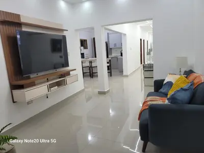 a living room with a tv and a couch at Colonial suites in Santo Domingo