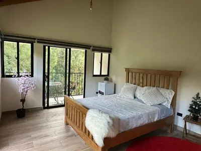 a bedroom with a bed in a room with windows at La gloria