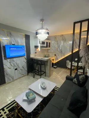 a living room with a couch and a table and a kitchen at Luxury and beautiful studio private jacuzzi in Santo Domingo
