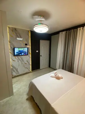a room with a bed and a tv on a wall at Luxury and beautiful studio private jacuzzi in Santo Domingo