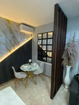 a dining room with a table and chairs and a window at Luxury and beautiful studio private jacuzzi in Santo Domingo