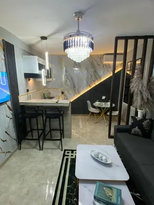 a living room and kitchen with a couch and a table at Luxury and beautiful studio private jacuzzi in Santo Domingo