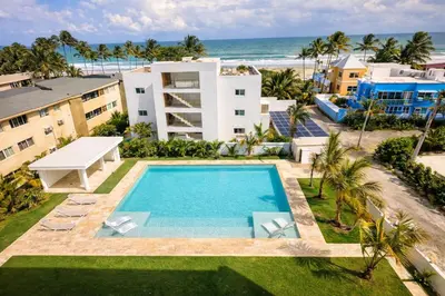 an aerial view of a resort with a swimming pool and the beach at Sunset Calm Penthouse in Cabarete
