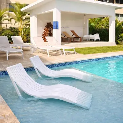 a swimming pool with two chairs and a swimming pool at Sunset Calm Penthouse in Cabarete