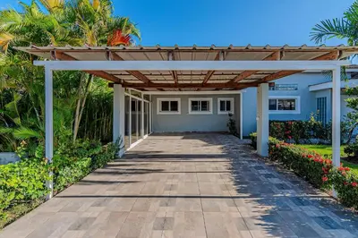 a wooden walkway leading to a house with a pergola at Villa Ocean Dream 3BR Oasis and guesthouse in Sosúa