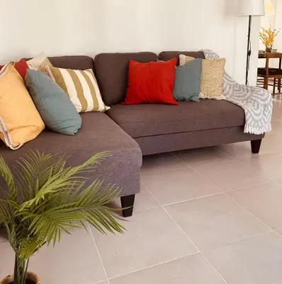 a couch with pillows on it in a living room at Oasis in Graditti valley in Santiago de los Caballeros