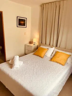 a bedroom with a bed with two pillows on it at Oasis in Graditti valley in Santiago de los Caballeros