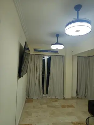 a living room with two lights and curtains at Torre chalom in Santo Domingo