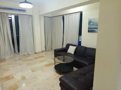 a living room with a couch and a table at Torre chalom in Santo Domingo
