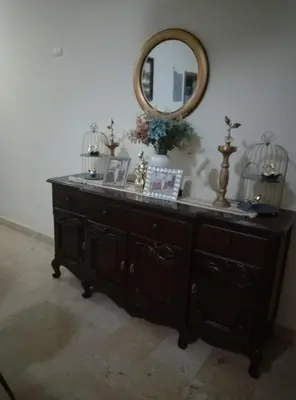 a wooden dresser with a mirror on top of it at Torre shalom in Santo Domingo