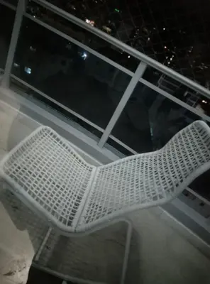 a white chair sitting on top of a window at Torre shalom in Santo Domingo