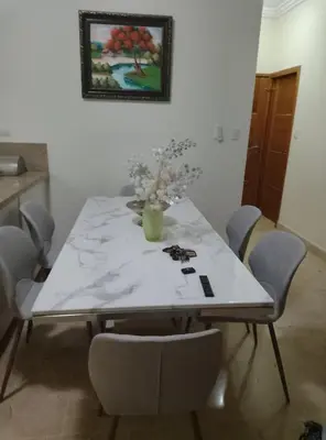 a dining room table with a vase of flowers on it at Torre shalom in Santo Domingo
