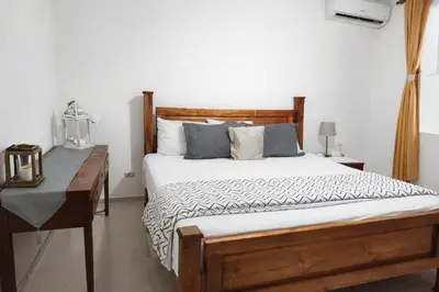 a bedroom with a wooden bed and a desk at Million View Room Adults Only Resort 2 in La Laguna