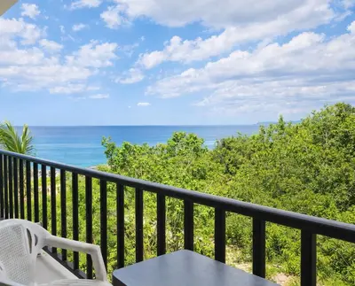 a balcony with a table and chairs and the ocean at Million View Room Adults Only Resort 2 in La Laguna