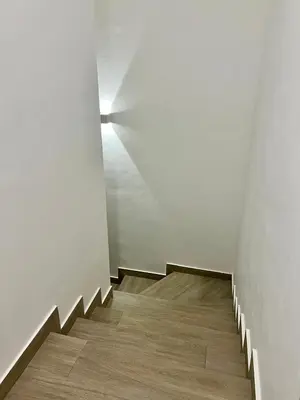 a stairway with a white wall and a stair case at Laggo one houses in Punta Cana