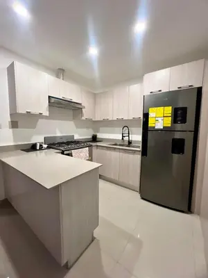 a kitchen with a stainless steel refrigerator and white cabinets at Laggo one houses in Punta Cana