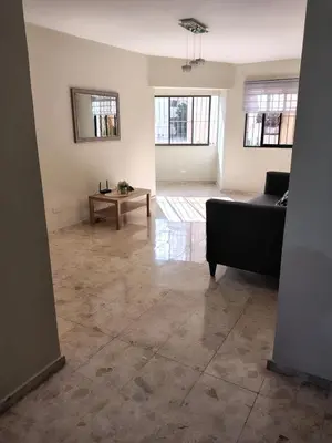 a living room with a couch and a table at Comfortable and quiet single room in Santo Domingo