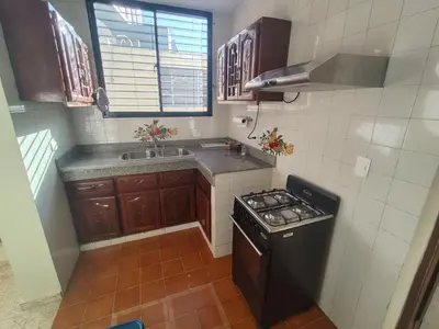 a small kitchen with a stove and a sink at Comfortable and quiet single room in Santo Domingo