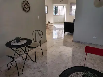 a living room with a table and chairs at Comfortable and quiet single room in Santo Domingo