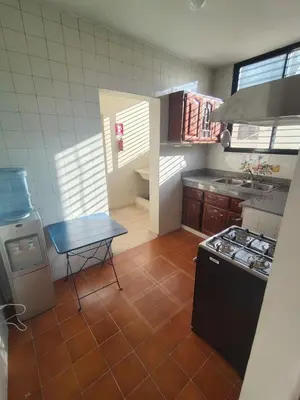a small kitchen with a table and a stove at Comfortable and quiet single room in Santo Domingo
