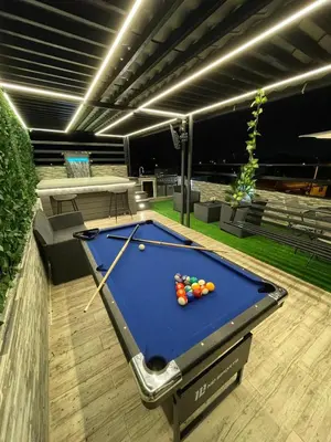 a pool table with balls on it on a patio at Luxury apartment private rooftop & jacuzzi in Santo Domingo