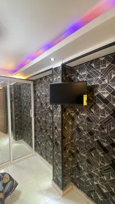 a tv on a wall in a room at Luxury Beautiful mini apartment Private jacuzzi in Santo Domingo