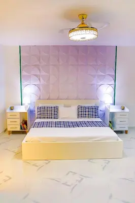 a bedroom with a bed and a purple wall at Agapimou apartments H in Gaspar Hernández