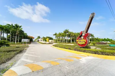 a guitar is sitting on the side of a road at Golf View Penthouse with Private Rooftop & BBQ in Punta Cana