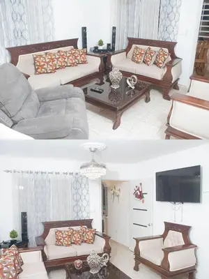 a living room with two couches and a tv at Apartamentos carrasco in Nagua