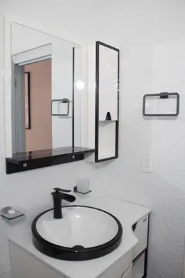a bathroom with a sink and a mirror at Apartamentos carrasco in Nagua