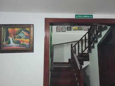a stairway with a painting and a sign on the wall at Hacienda Francisco in Concepción de La Vega