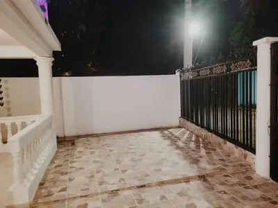 a porch with a white fence and a tile floor at Hacienda Francisco in Concepción de La Vega
